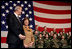 Laura Bush stands with U.S Ambassador to Italy Ron Spogli before speaking with troops during a visit to Aviano Air Base, in Aviano, Italy, Friday, Feb. 10, 2006. White House photo by Shealah Craighead 