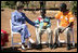 Mrs. Laura Bush talks with Raphael Lungo, 10, during a discussion with caregivers and beneficiaries of the Mututa Memorial Center Thursday, June 28, 2007, in Lusaka, Zambia. The center provides many humanitarian services including home-based care for people living with HIV/AIDS, care for orphans and promotes abstinence and faith for youth.