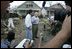 Vice President Dick Cheney walks with Mayor Gregg Warr, Thursday, Sept. 8, 2005, through a neighborhood in Gulfport, Miss., devastated by Hurricane Katrina, as they talk with surviving residents.