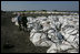 Vice President Dick Cheney talks with a members of the US Army Corp of Engineers during a tour of the 17th street levee repair operations in New Orleans, Louisiana Thursday, September 8, 2005. The Vice President's tour of the city includes visits with police and EMS personnel working in the area.