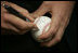 President George W. Bush autographs baseballs Thursday night, April 14, 2005, before his appearance before an opening-night Washington Nationals crowd at RFK Stadium.  The President was on hand to throw out the first pitch during a ceremony marking the return of major league baseball to the Capitol.