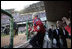 President George W. Bush acknowledges the applause as he exits the dugout Thursday, April 14, 2005, to throw out the first pitch at the Washington Nationals' home opener.  The President's appearance proved good luck as the Nationals defeated the Arizona Diamondbacks, 5-3.