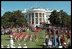 Playing for a large crowd of press and visitors, the U.S. Army Old Guard Fife and Drum Corps march across the South Lawn during the State Arrival Ceremony.