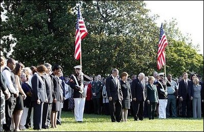 Honoring the memory of those who died during terrorist attacks on this day two years ago, President George W. Bush, Laura Bush, Vice President Dick Cheney and Lynne Cheney stand with White House staff for a moment of silence on the South Lawn 8:46 a.m., Thursday, Sept. 11, 2003.