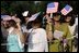 Invited guests shade their eyes, Monday, July 18, 2005, during the official arrival ceremony for India's Prime Minister Manmohan Singh on the South Lawn of the White House. 