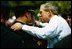 President George W. Bush talks with officers at the Annual Peace Officers' Memorial Service at the U.S. Capitol in Washington, D.C., Saturday, May 15, 2004. "In the Memorial, and in countless acts of love and kindness, the fallen are remembered and honored. And this afternoon, on behalf of all Americans, I offer the respect of a grateful nation," said the President. "Their calling in life was to keep the peace."