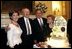 President George W. Bush and Laura Bush pose with former President Gerald R. Ford and wife Betty Ford during the presentation of the birthday cake at the Dinner in Honor of President Ford's 90th Birthday at the White House, Wednesday, July 16, 2003.