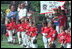 President George W. Bush and Cal Ripken stand for the singing of the national anthem during the opening ceremony of the first game of the White House Tee Ball season Sunday, May 5, 2002. Mr. Ripken is serving as the honorary commissioner of the White House T-ball League.