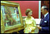 Rosalynn Carter admires a painting in the Red Room with White House Curator Clem Conger September 28, 1977.