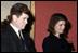 With her brother-in-law Edward Kennedy at her side, Jacqueline Kennedy greets guests in the Red Room following the funeral for her husband, President John Kennedy.