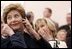 Laura Bush listens to translation headphones during a joint press conference with President George W. Bush and German Chancellor Gerhard Schroeder at the Electoral Palace in Mainz, Germany, Wednesday, Feb. 23, 2005. The Chancellor’s wife, Mrs. Schroeder-Koepf is seated next to Mrs. Bush. 