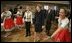 Laura Bush watches dancers during a Wednesday, Feb. 23, 2005, lunch hosted by Chancellor Gerhard Schroeder, behind, and Mrs. Schroeder-Koepf, left, at the Electoral Palace in Mainz, Germany. 