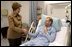 Laura Bush visits with U.S. Army Specialist Garrett Larson who is recovering from injuries sustained in Iraq at the Landstuhl Regional Medical Center Tuesday, Feb. 22, 2005, in Ramstein, Germany. 