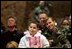 Audience members listen to a speech by Laura Bush praising the sacrifice and hard work of the U.S. military and their families Tuesday, Feb. 22, 2005 at Ramstein Air Base in Ramstein, Germany. 