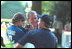 Greeting the players and coaches, President Bush makes new friends while hosting the third tee-ball game at his home during the third Tee Ball game on the South Lawn on Sunday, July 15, 2001.