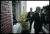 President George W. Bush reaches out for the hand of a well-wisher after participating in the 2005 class photo during opening ceremonies Friday, Nov. 4, 2005, of the Summit of the Americas in Mar del Plata, Argentina.