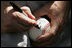 President George W. Bush autographs baseballs for players and guests at the White House Sunday, July 30, 2006, during the Tee Ball on the South Lawn game between the Thurmont Little League Civitan Club of Frederick Challengers of Thurmont, Md., and the Shady Spring Little League Challenger Braves of Shady Spring, W. Va. 