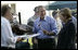 President George W. Bush enjoys a bit of barbeque Thursday, July 13, 2006, as he joins Chancellor Angela Merkel for a barbeque in Trinwillershagen. The President and Mrs. Laura Bush are scheduled to depart Germany Friday for St. Petersburg, Russia.