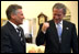 Before starting the first meeting of the day, Presidents Bush and Kwasniewski talk privately in the Oval Office July 17. White House photo by Eric Draper.