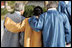 Robed in traditional garb, President George W. Bush walks arm-in-arm with Japan's Prime Minister Junichiro Koizumi, right, and Peru's President Alejandro Toledo outside the Nurimaru APEC House in Busan, Korea, Saturday, Nov. 19, 2005, for the APEC official photograph.