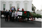 Mrs. Laura Bush stands with the Botek family of Lehighton, Pa., as she receives the official White House Christmas tree on the North Portico Monday, Nov. 27, 2006. The Botek family owns the Crystal Springs Tree Farm and donated the 18-foot Douglas fir tree. 