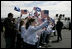 President George W. Bush and Laura Bush are greeted by ceremony and cheers upon their arrival at Glasgow Prestwick International Airport in Scotland July 6, 2005.