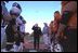 Vice President Dick Cheney flips a coin to begin the homecoming football game between the Natrona County High School Mustangs, right, and Cheyenne Central High School Indians, left, in Casper, Wyo., Sept. 20, 2002. The Mustangs won the game 24-6.