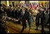 President George W. Bush and Laura Bush exit the East Room following the President's remarks commemorating the one-year anniversary of operation Iraqi Freedom and the efforts of his administration and 91 nations to ensure peace and stability in Iraq, Afghanistan and the Greater Middle East March 19, 2004.