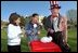 Hopping from activity to activity, two girls stop to pet a real Easter bunny.