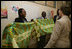 Mrs. Bush admires the decorative welcoming banner as she arrives to visit the Korle-Bu Treament Center, Tuesday, Jan. 17, 2006 in Accra, Ghana.