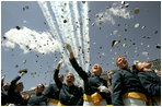 Graduates toss their hats into the air as the contrails from five F-16's stream overhead during the U.S. Air Force Academy graduation in Colorado on Wednesday, June 1, 2005. Nine hundred and six graduates became commissioned officers in the U.S. Air Force after their four-year curriculum that began shortly before September 11, 2001.