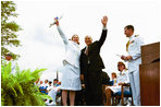 Following his commencement address to the U.S. Coast Guard Academy, Vice President Dick Cheney and Cadet Jen Frye, 22, of New Market, VA, wave to her friends and family after he presented the graduating cadet her commission in New London, Conn., Wednesday, May 19, 2004.