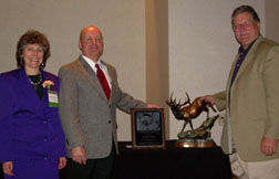 Photograph:  Anne Zimmermann (USFS Director of WFW) poses with Norm Weiland and Tom Darden.  Norm and Tom display their awards.