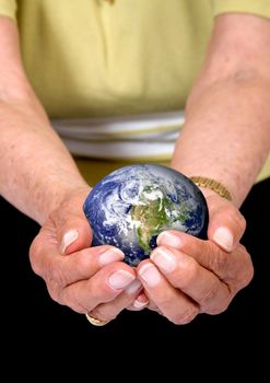 a woman's hands holding the globe