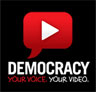 Democracy Video Contest Logo: Conversation bubble with play video button superimposed on it and the words democracy - your voice, your video below.