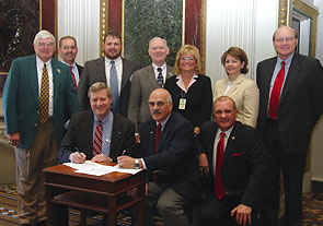 Front row: L-R OSHA Assistant Secretary Edwin G. Foulke, Jr. and Al Lucchetti - President, AFS sign a national Alliance renewal agreement on April 28, 2006. Back row: Members of the AFS 10-Q Committee