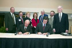 Front row: AFS President, H. Arthur Edge, and OSHA’s then-Assistant Secretary, John Henshaw sign the AFS Alliance Agreement Back row: Members of the AFS 10-Q Committee.
