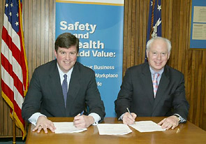 L-R OSHA's then-Acting Assistant Secretary, Jonathan L. Snare and Richard Jennison, President & CEO, BIA sign National Alliance agreement on March 20, 2006.