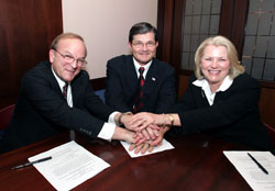 Dennis O'Leary, President, JCAHO, OSHA's then-Assistant Secretary, John Henshaw and Karen Timmons, President and CEO, JCR, sign national Alliance July 27, 2004.