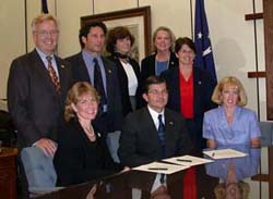 Representatives of ABSA and OSHA gathered round John Henshaw, Assistant Secretary for Occupational Safety and Health, and Maureen Best, President of ABSA, after they signed the National Alliance on September 23, 2002