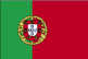 Flag of Portugal is two vertical bands of green--hoist side, two-fifths--and red--three-fifths--with the Portuguese coat of arms centered on the dividing line.