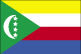 Flag of Comoros is four equal horizontal bands of yellow at top, white, red, and blue with green isosceles triangle based on hoist; centered within triangle is white crescent with convex side facing hoist and four white, five-pointed stars placed vertically in line between points of crescent.