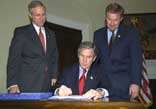 President George W. Bush signs H.R. 2458, The E-Government Act of 2002, in the Roosevelt Room Dec. 17, 2002.
										White House photo by Paul Morse