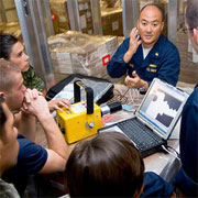 Cmdr. Joseph Yang instructs Pacific Partnership personnel in the use of medical equipment.
