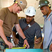 July 17 - U.S. Navy builder Mike Howe works with local villagers Toofohe Tuivailala and Saiti Makaafi during Pacific Partnership 2009.