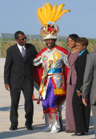 Secretary Rice is greeted on arrival by Olympic Sprinter Ms. Eldece Clarke-Lewis, Bahamian Foreign Minister Mitchell and a traditional Bahamian junkanoo band member in Nassau, Bahamas March 21, 2006. 