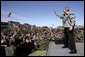 President George W. Bush waves to the troops at Fort Hood, Texas, as he arrived Tuesday, April 12, 2005, to thank them in person for their service in Iraq. "Americans are grateful for your sacrifice and your service," the President told a large portion of the 44,188 soldiers and airmen stationed at the base. ".And so is your Commander-in-Chief."  White House photo by Eric Draper