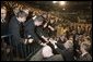 President George W. Bush reaches out to Midshipmen at the United States Naval Academy Wednesday, Nov. 30, 2005, in Annapolis, Maryland, where he spoke on the War on Terror. The President thanked the Midshipmen for volunteering to serve and told them America is grateful for their devotion to duty.  White House photo by Paul Morse