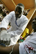 A medical lab technician takes samples of blood at the voluntary councelling and testing centre (AP Photo).