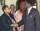 Assistant Secretary Frazer shakes hands with Kenyan opposition leader Raila Odinga during her recent vist to Kenya.  AP Photo.